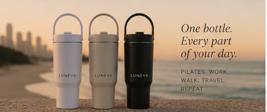Cloud, Oat, and Noir LUNÉVA bottles overlooking the coast